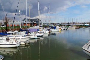 A view of Nieuwpoort harbour in Belgium. It looks out over the marina along the harbour entrance channel towards The English Channel.